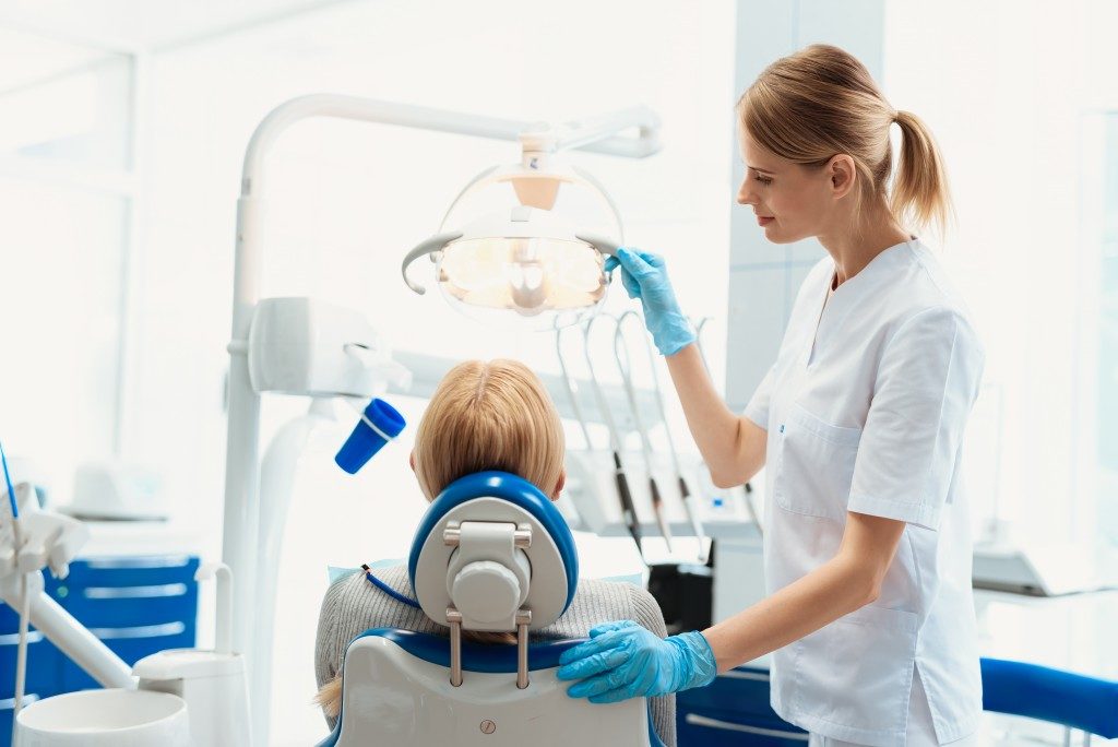 Patient with dentist sitting on dentist chair