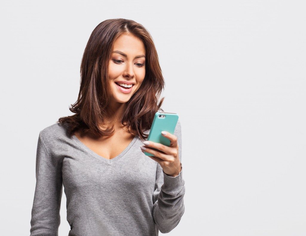 Woman using mobile app on phone