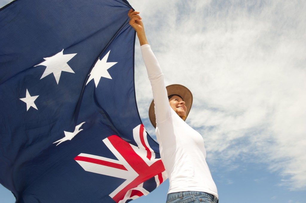 woman carrying the flag of Australia