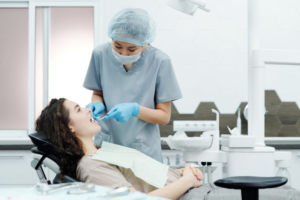 dentist operating her patient
