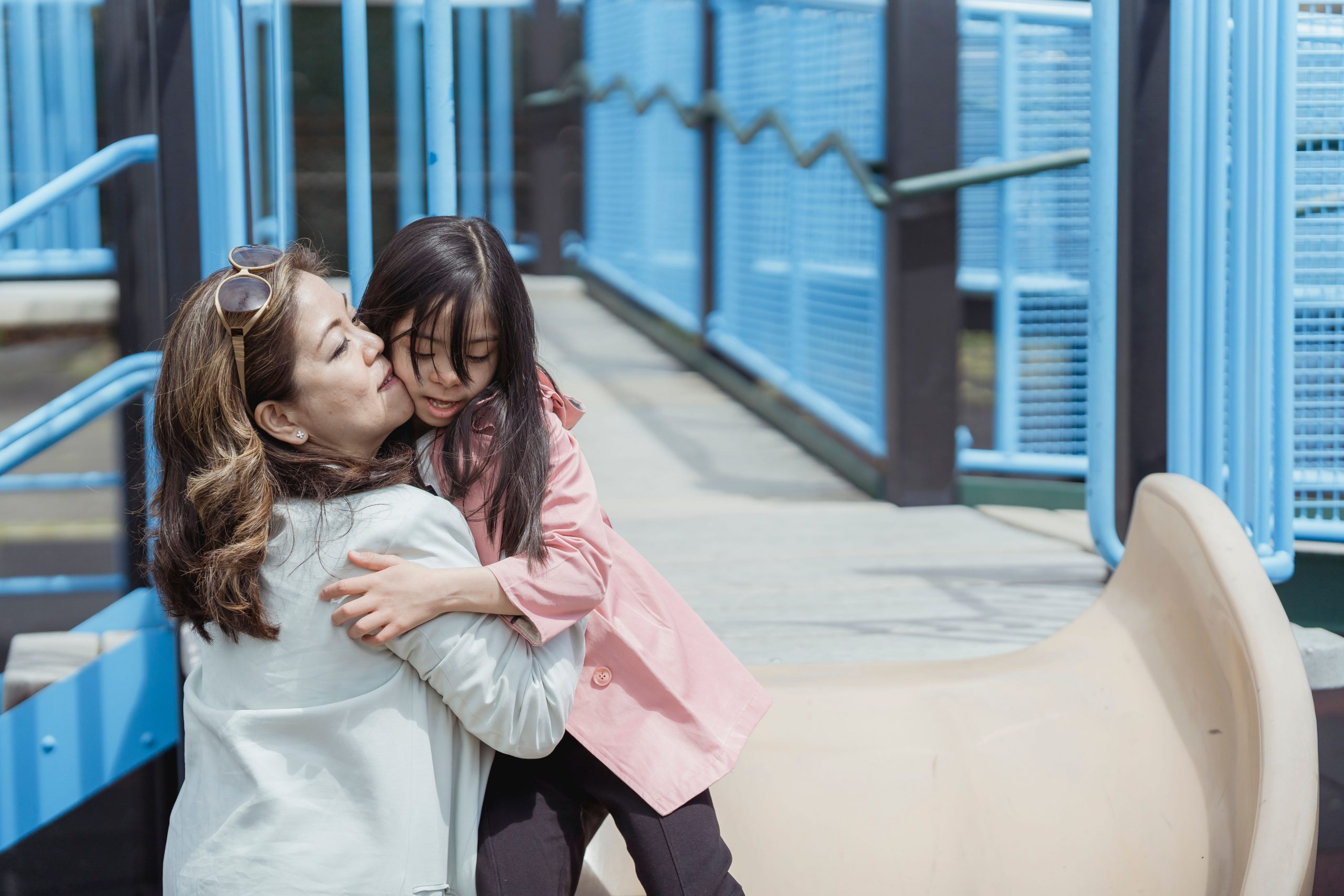 mother playing with her daughter at a playground